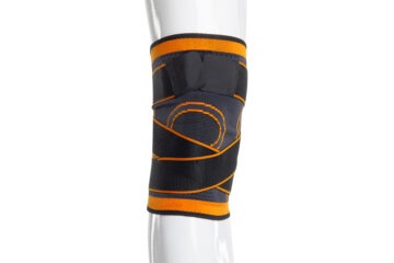 Bandage de genou de soutien avec une large fermeture velcro de 5 cm - orange-noir